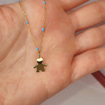 9ct Gold Little Boy Pendant on 9ct Gold Chain in a persons hand