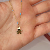 9ct Gold Little Boy Pendant on 9ct Gold Chain in a persons hand