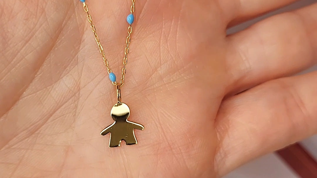 9ct Gold Little Boy Pendant on 9ct Gold Chain in a persons hand