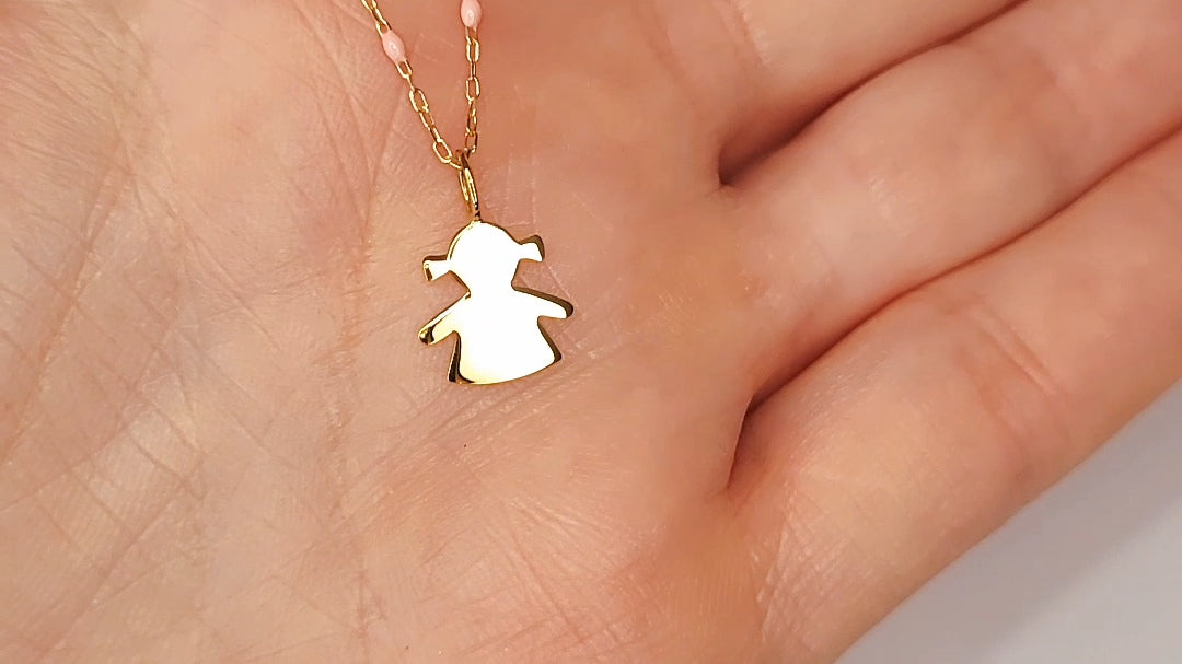 9ct Gold Little Girl Pendant on 9ct Gold chain with Pink Enamel detail in a persons hand