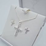 Close-up of sterling silver CZ cross pendant and cubic zirconia earrings for Holy Communion