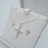 Close-up of sterling silver CZ cross pendant and cubic zirconia earrings for Holy Communion