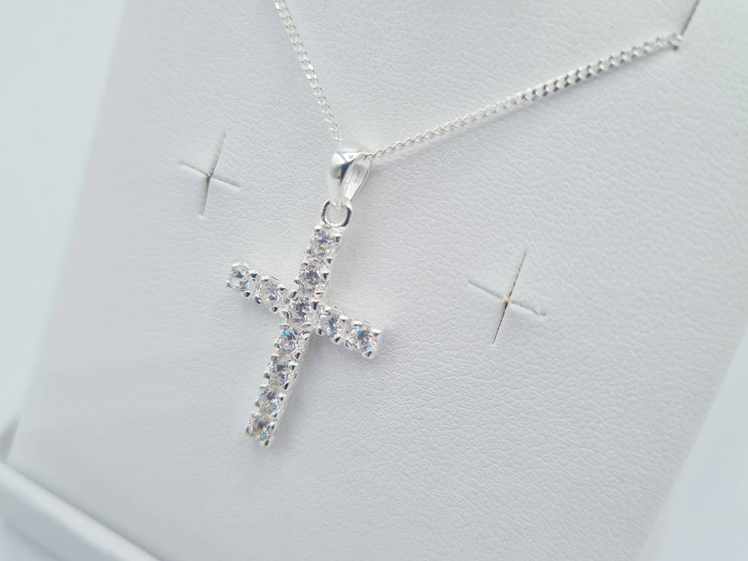 Close-up of sterling silver CZ cross pendant on chain – First Holy Communion jewellery