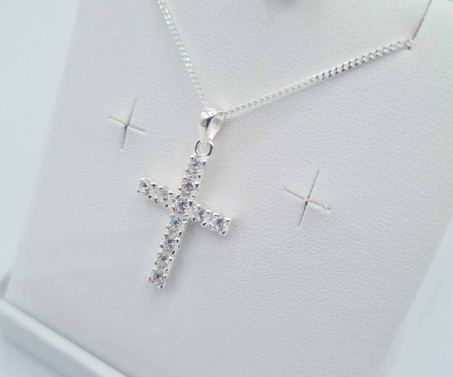 Close-up of sterling silver CZ cross pendant on chain – First Holy Communion jewellery