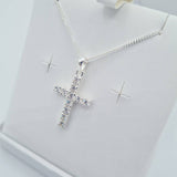 Close-up of sterling silver CZ cross pendant on chain – First Holy Communion jewellery